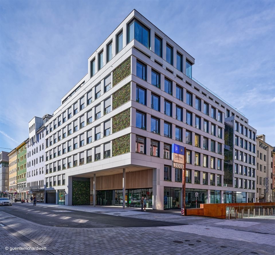 Zentrale der Tiroler Versicherung in Innsbruck — Bürogebäude mit begrünter Fassade an einer Straßenecke